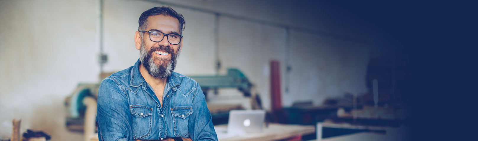 an early-middle-aged man smiles because he successfully repaired his own hearing aids